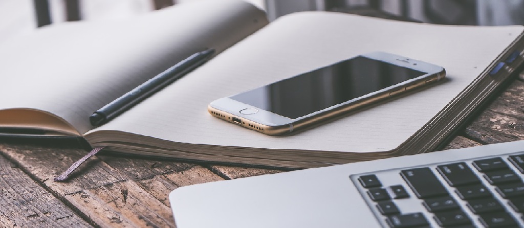 Phone and notebook on the table